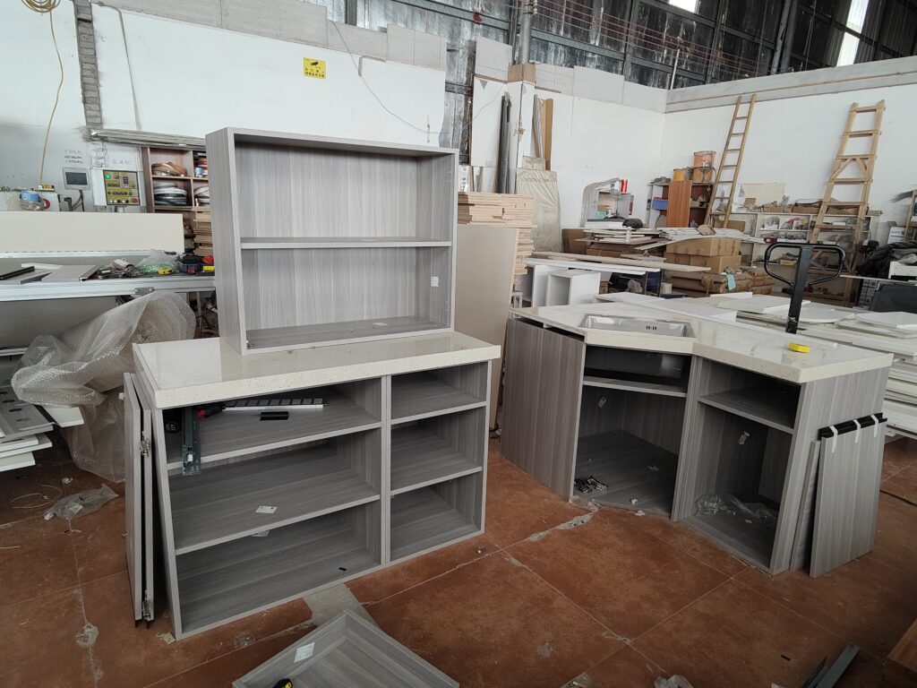 Wide-angle view of complete pre-assembled kitchen cabinet layout for French client