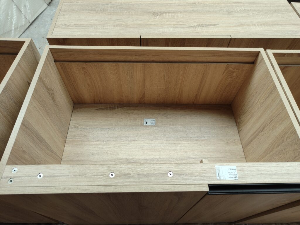 Close-up inspection of drawer-box construction, screw fastening and component labels