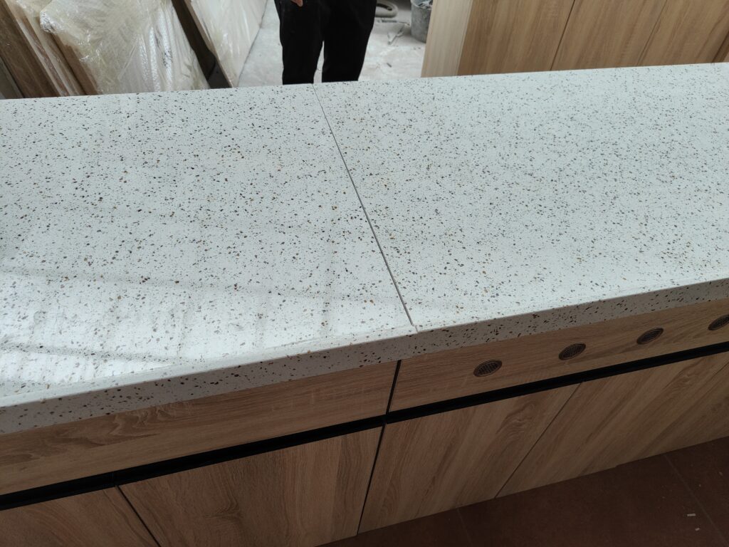 Quartz countertop seam inspection during preassembly for France kitchen cabinet project 